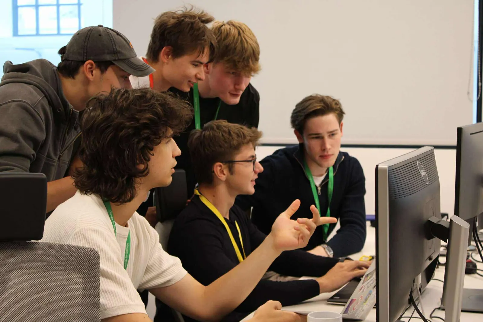 Codaro team members gathered around one monitor