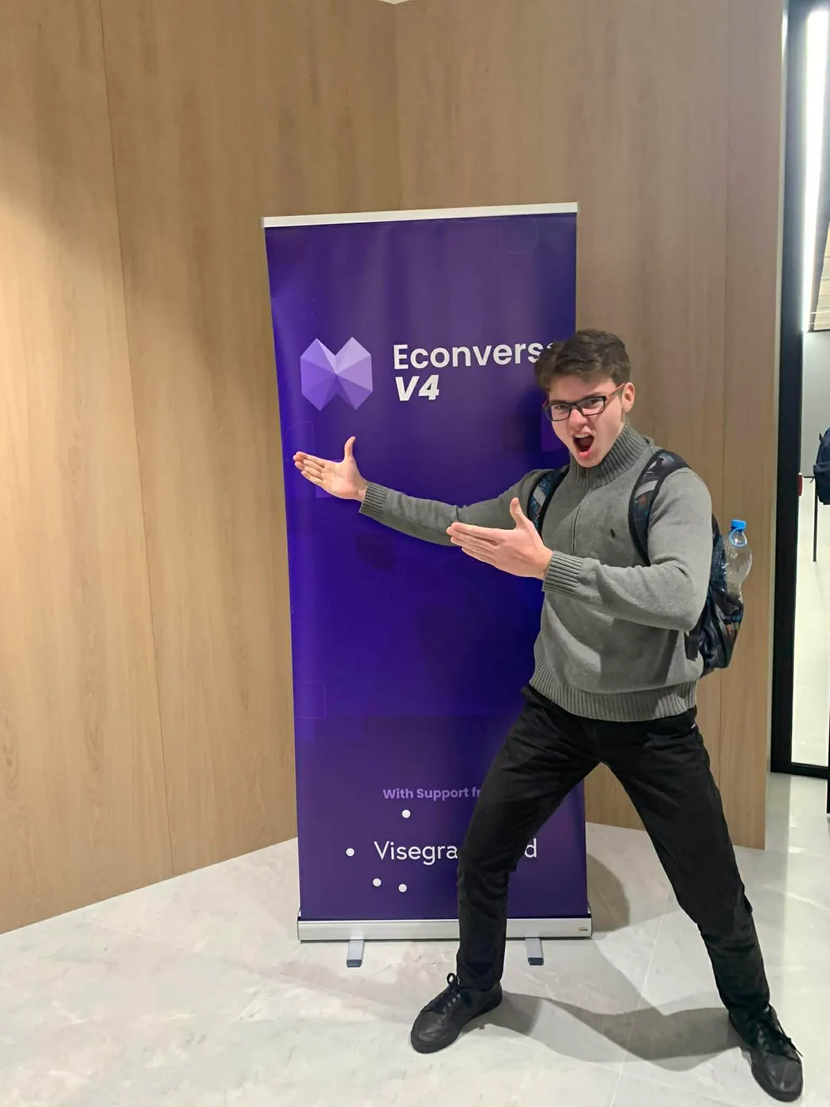 Participant posing by the Econverse V4 roll-up