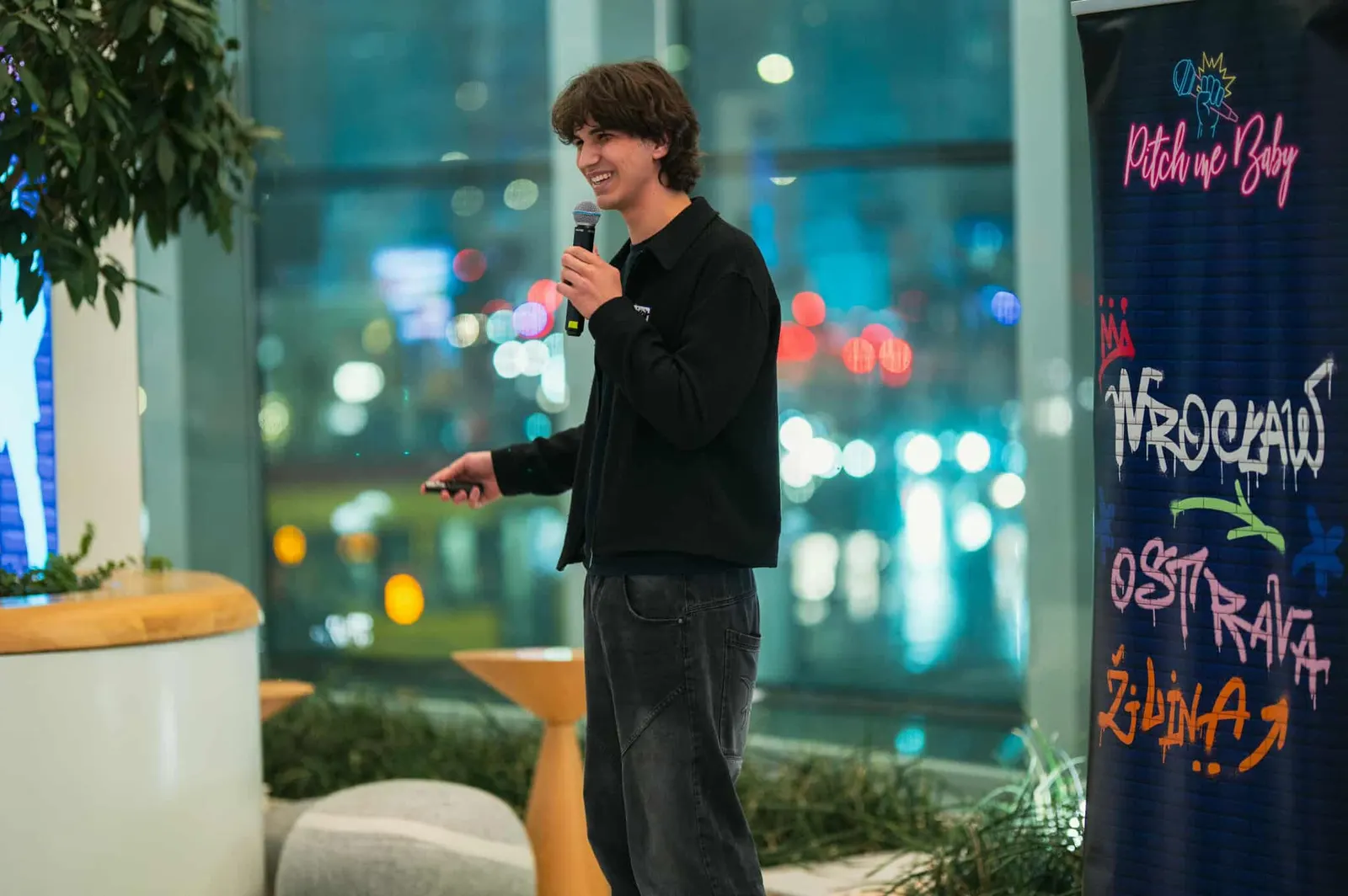 Speaking with a microphone at a startup event